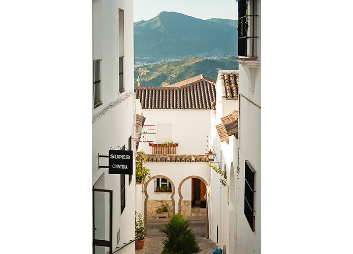 Pristine whitewashed houses line the village's quaint cobbled streets.