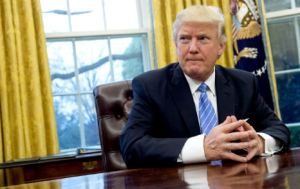 Donald Trump settles into the Oval Office at the White House. Photo: AFP